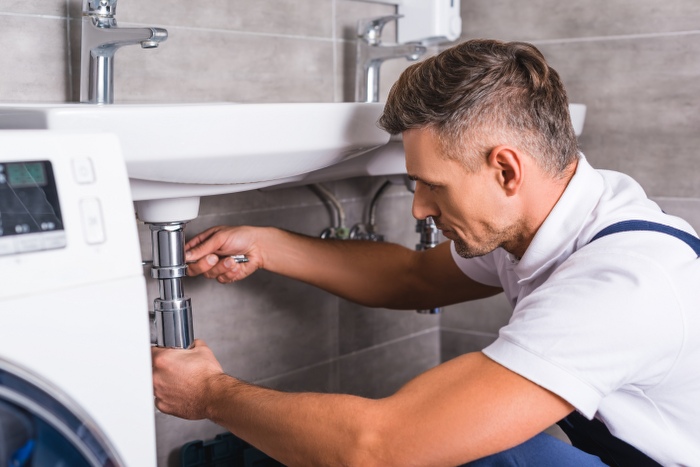 plumber fixing sink