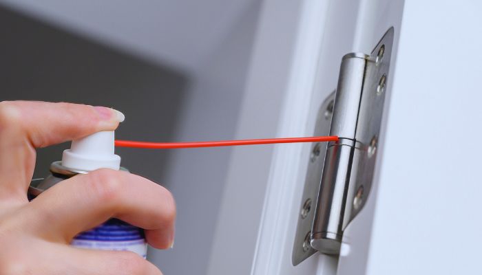 applying oil on door